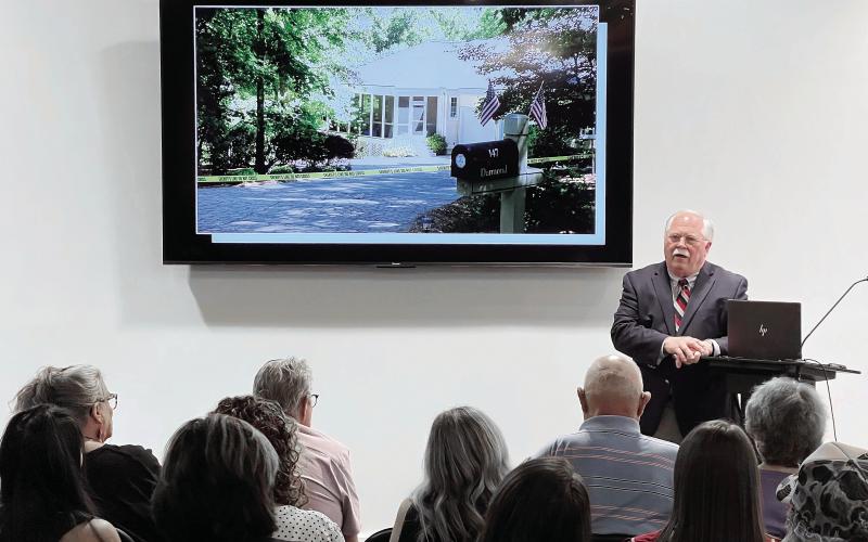 With a photo of the Dermonds’ Great Waters home on the TV mounted behind him, Putnam County Sheriff Howard Sills presents the evidence gathered so far in what he admits is the “toughest case” of his career so far. IAN TOCHER/Staff