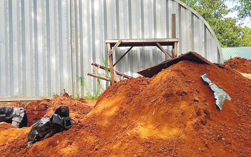 Behind the metal work shed, authorities found fresh dirt. CONTRIBUTED/Sheriff Howard Sills