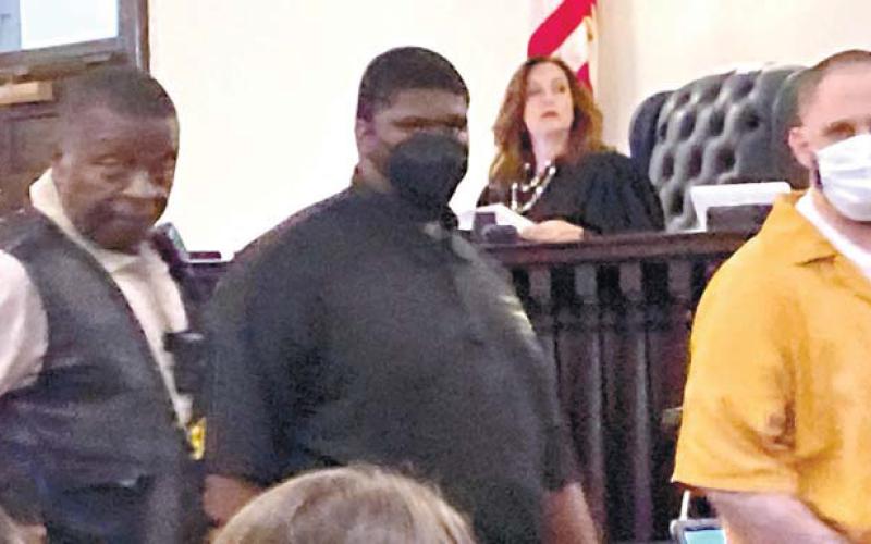 Christopher Demmon looks at and speaks to the victim’s family as he is escorted out of the courtroom. LYNN HOBBS/Staff