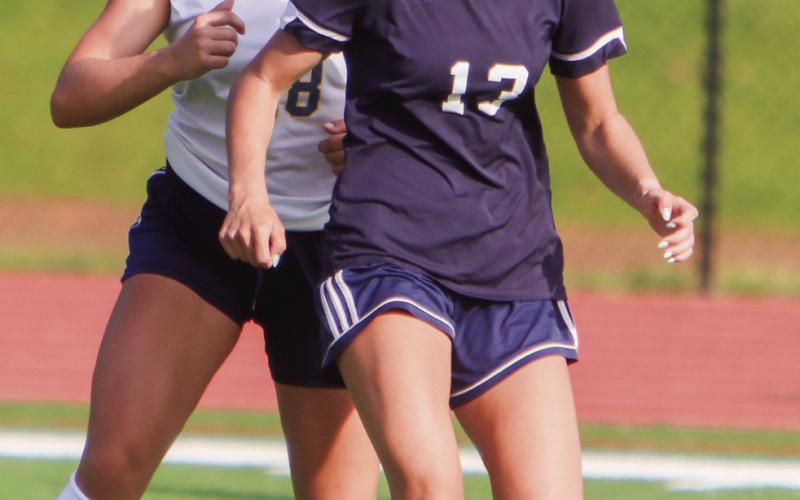 Putnam County senior Lily Frisch (13) tries to dribble to ball away from a Jeff Davis defender. (LANCE MCCURLEY/Staff)