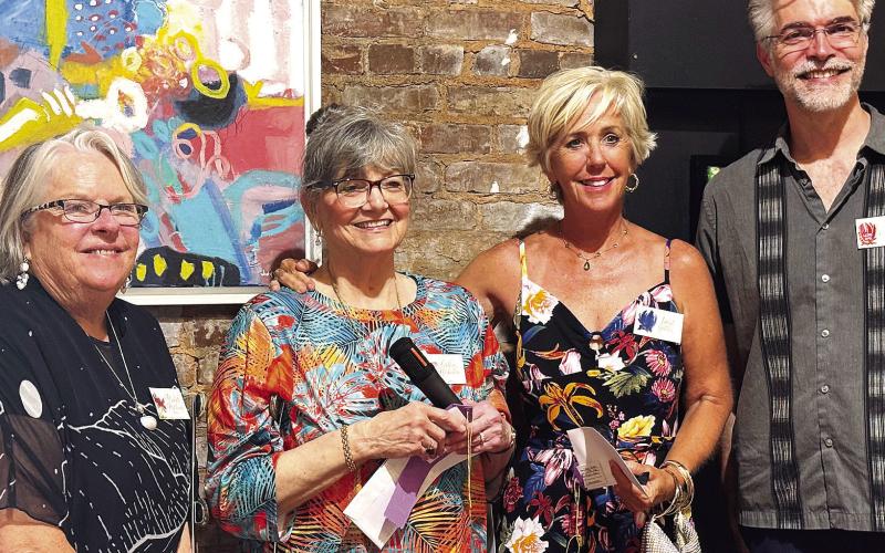 Art show chairperson Michele Hartung and co-chair Cathy McIntire congratulate Merit Award winner Janet Getter alongside art judge Shane McDonald. MELANIE SCHNEIDER/CONTRIBUTED