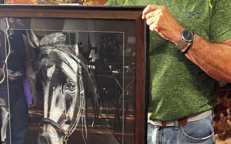 Despite becoming an artist just two years ago, Dr. Edward Hubach won the prestigious Peoples’ Choice vote for his lifelike painting, “Fury,” depicting the head of a black horse. IAN TOCHER/Staff