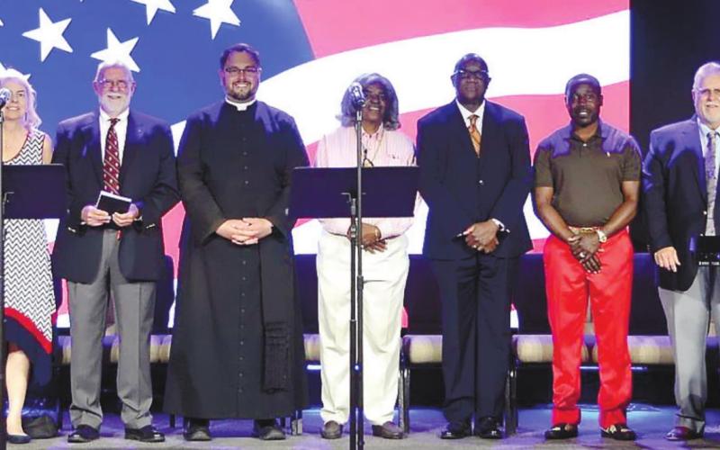 Prayer participants include, from left, Rob Reiner, Mark Jones III, Tim Oliver, Rosa Sides, AJ Bryant, Meg Jackson Clark, Ford G’Senger, Father Michael Silloway, Avis Williams, Herman Laguins, Mayor Corey Williams, Dennis Mitchell, Havier Ortiz, Edith Ortiz, Lee Smith, Jonathon Dawson and Fran D’Antonio. CONTRIBUTED