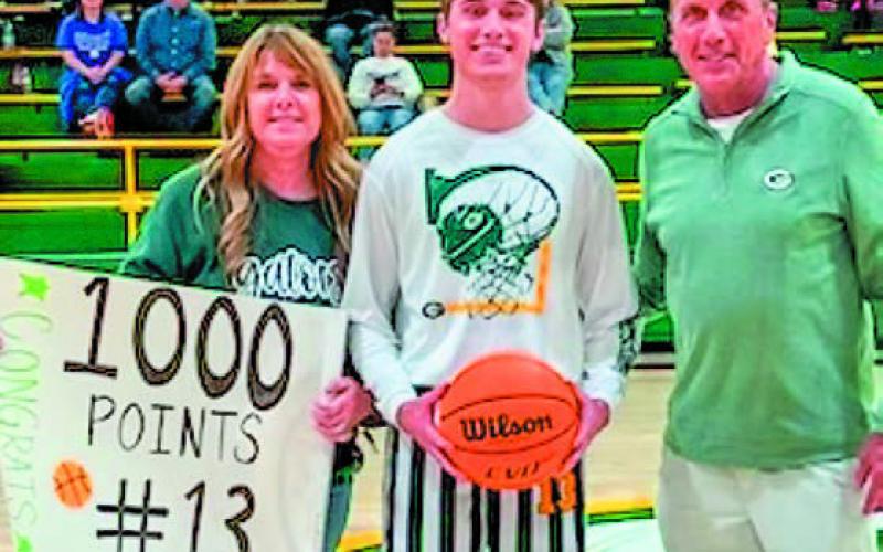 Kaden Keiser (middle) poses for a photo with his parents after the game. CONTRIBUTED