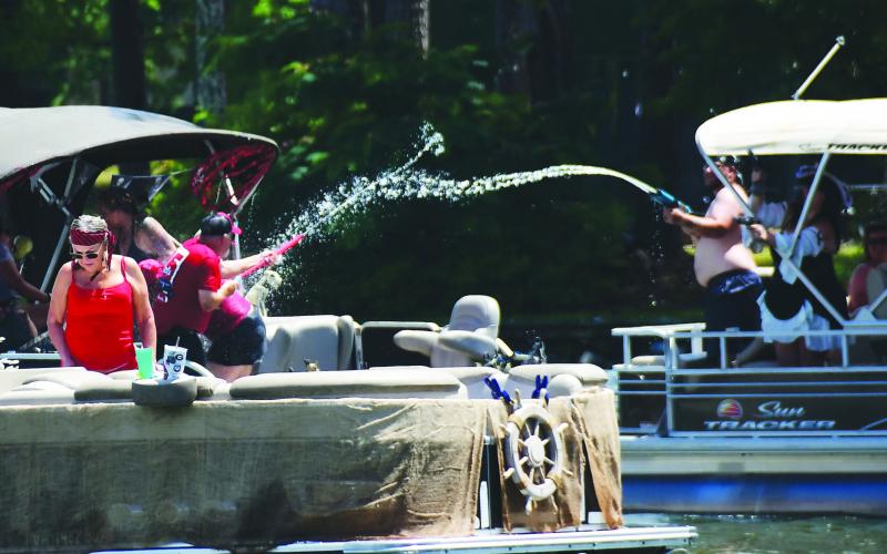 A pair of Pirate Parade participants engaged in a spirited battle as they pulled into Crooked Creek Marina on Saturday for landside festivities.