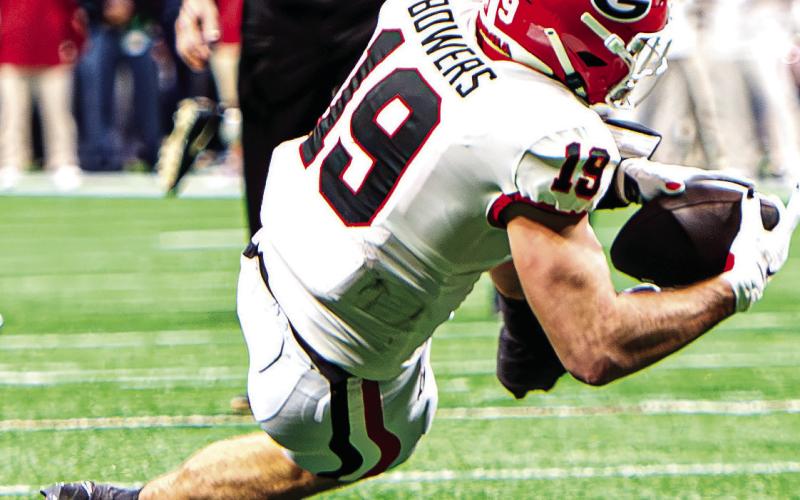 Georgia tight end Brock Bowers (19) may have suited up for the Bulldogs for the last time pending his Orange Bowl decision. CHARLES JORDAN/Staff