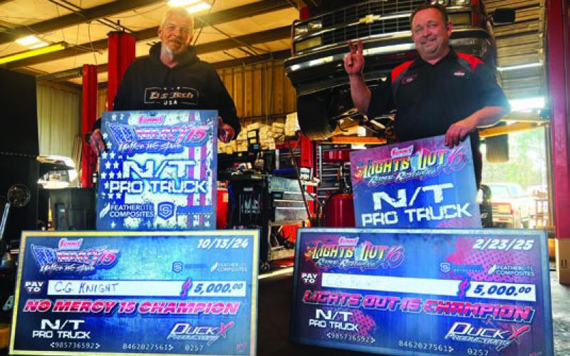 Eatonton’s C.G Knight (right) and his “main man,” Doug Colbert, hold the ceremonial checks he received after winning two Duck X events over the last few months at South Georgia Motorsports Park, near Valdosta. IAN TOCHER/Staff