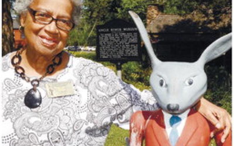 Georgia Benjamin-Smith (left) with her "critter" friend Brer Rabbit outside the Uncle Remus Museum in Eatonton.  IAN TOCHER/Staff
