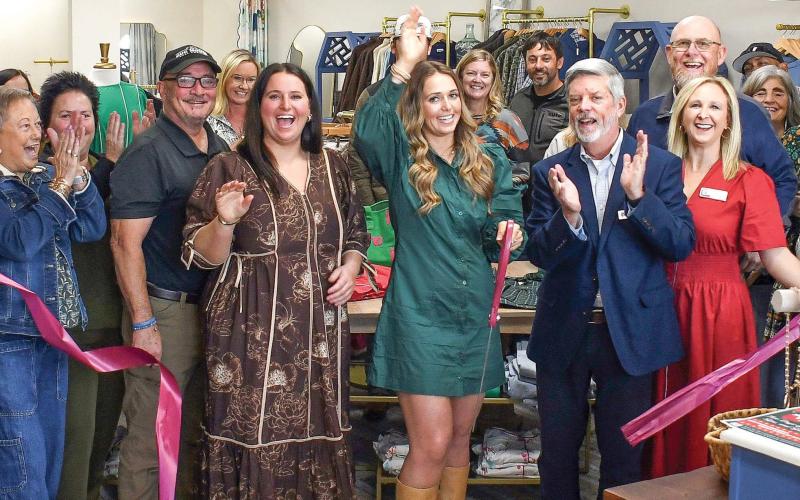 Sisters Megan and Mallory Fitzgerald (l-r, center) celebrate with friends and family at the official ribbon cutting Nov. 14, for their new Three Rays Boutique &amp;amp; Head Spa at 646 Old Phoenix Rd., Eatonton. IAN TOCHER/Staff
