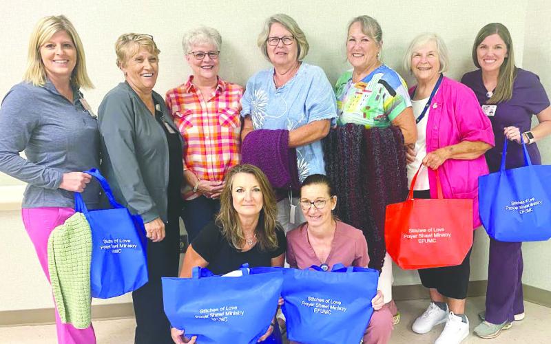 Felicia McDonel, Carole Dunagan, Donna Birt, Debbie Skinner, Lou Rodeheaver, PGH Auxiliary President Joan Millines (with red bag) and Suzanne Culp, with PHG Case Manager Lisa English and Donna Price in front. CONTRIBUTED