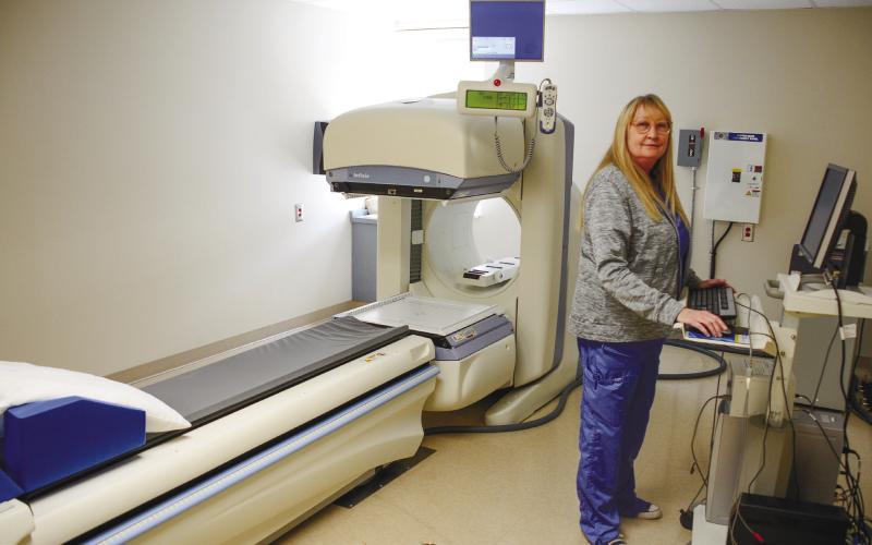 PGH Radiology Director Tina Cooper stands at the controls of a nuclear camera that can detect bone cancers, heart disease and gallbladder problems, among many other internal conditions.