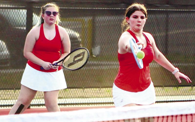 Carolyn Thomas gets a return in a doubles match victory with partner Cadence Fox. ARELLA CASH/Staff