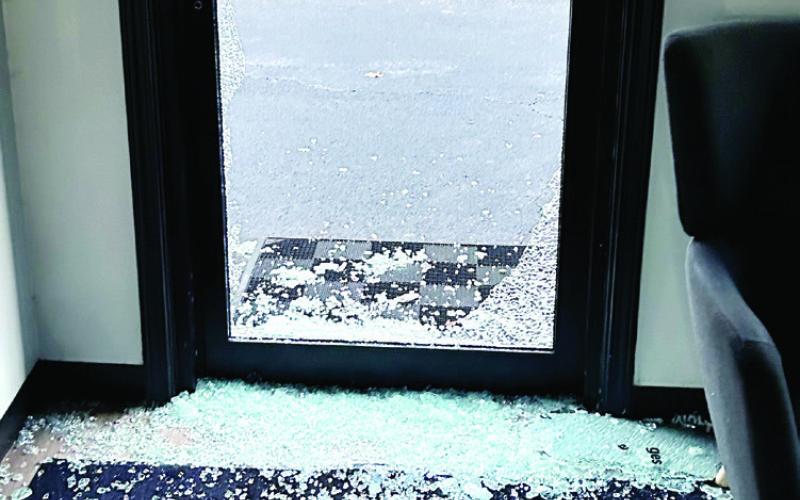 Shards of glass are scattered and piled around the back door of the Grease Monkey after burglars broke in early Wednesday morning. CONTRIBUTED
