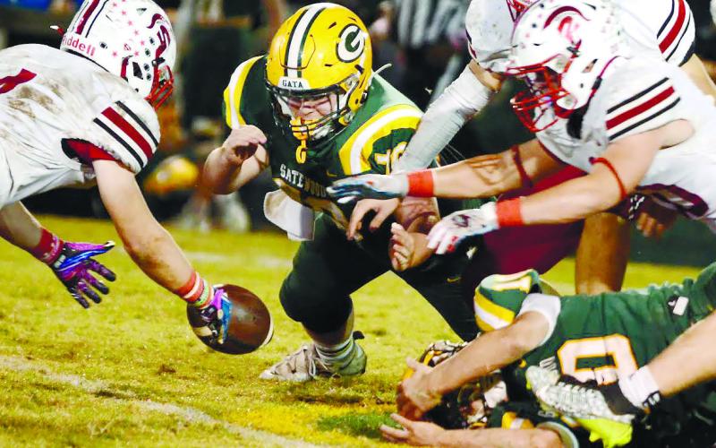 Tyler Middleton (center) made the effort for Gatewood Friday night, but the visiting Spartans came up with the ball after a lategame fumble by Gators quarterback Ames Johnson. IAN TOCHER/Staff
