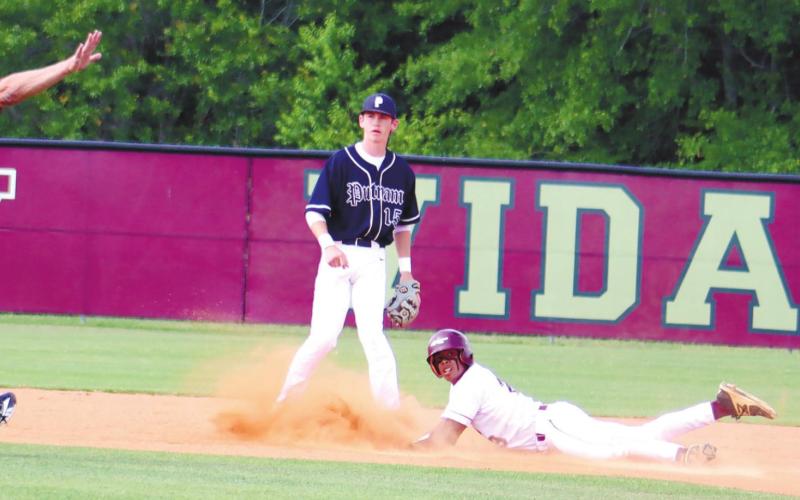 Two Putnam County infielders look on as an umpire calls the Vidalia baserunner safe at second. ARELLA CASH/Staff