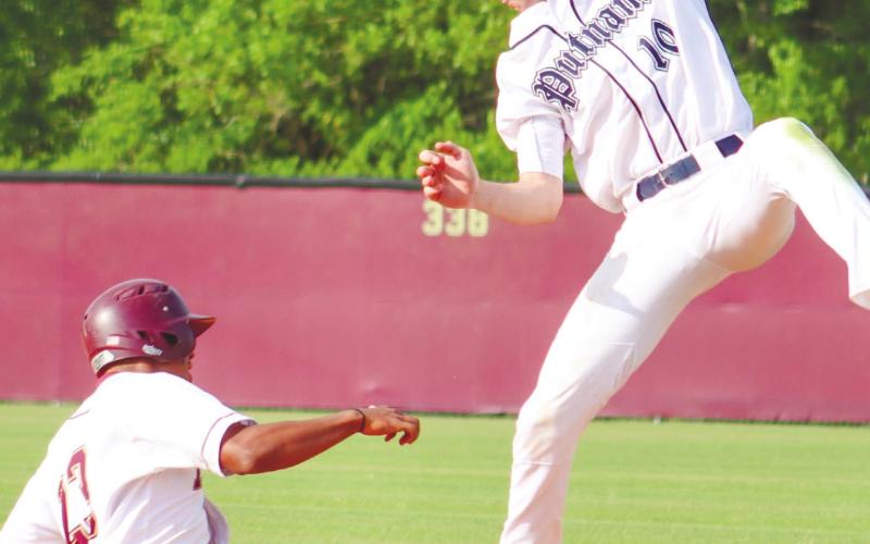 Dakota Jones (10) goes up and saves an overthrow, saving extra bases. ARELLA CASH/Staff