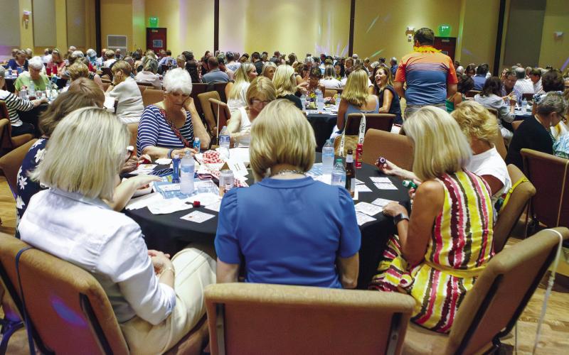 Participants are deep in concentration on the bingo cards as each number is announced. (LEIGH LOFGREN/Staff)