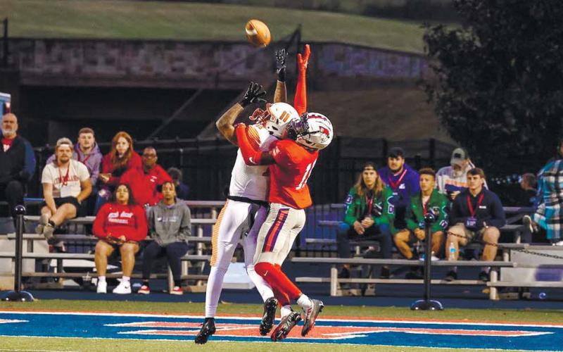 University of the Cumberlands cornerback Malik Thornton (right) reaches up to deflect a pass near the end zone. CONTRIBUTED