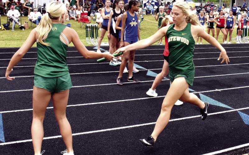 The Gatewood girls’ 800-meter relay team completes a handoff during the region meet held last Thursday in Eatonton. IAN TOCHER/Staff
