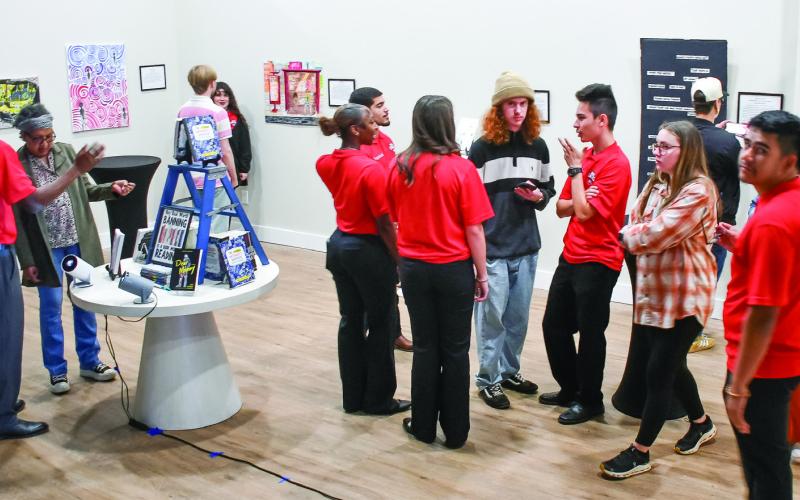 Putnam County High School students viewed and discussed several student-made artworks on display at the Georgia Writers Museum in Eatonton. IAN TOCHER/Staff