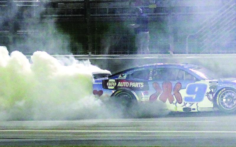 Chase Elliott celebrates Saturday night’s win at EchoPark Speedway with a burnout. BRAD HARRISON/Staff