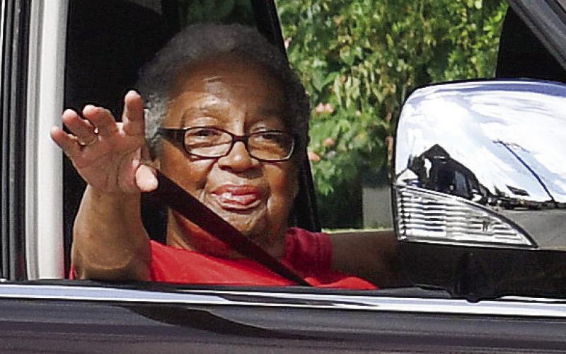 Mothers Against Crime’s Georgia Benjamin-Smith waves during the parade. IAN TOCHER/Staff