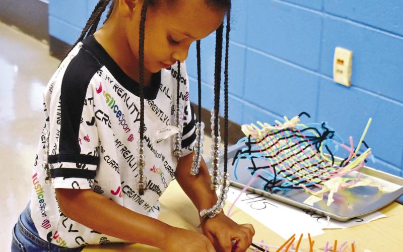 Lucy Dixon is finishing up her pencil holder. LENA HENSLEY/Staff