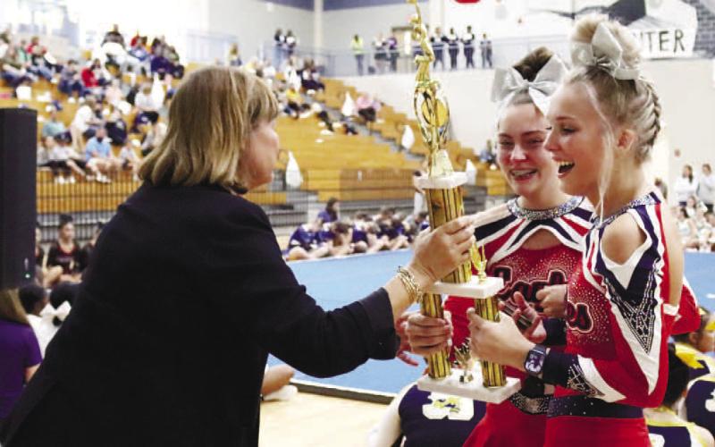 Members of the PCHS Cheer team hold up the Region 4-AA trophy.