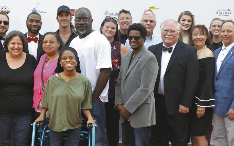 The cast of “83 Days,” the _lm which kicked o the 2019 Milledgeville-Eatonton Film Festival, pose together on the red carpet at The Plaza Arts Center in Eatonton. FILE PHOTO