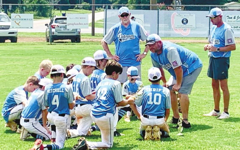 Post-Tourney Pep Talk: After a runner-up finish in the state championship tournament, coach Clyde Harper goes over the weekend’s events with the Putnam County 10U Dixie Youth All-Stars while head coach Grayson Huskins (far right) and co-coach Danny Peterson look on. CONTRIBUTED