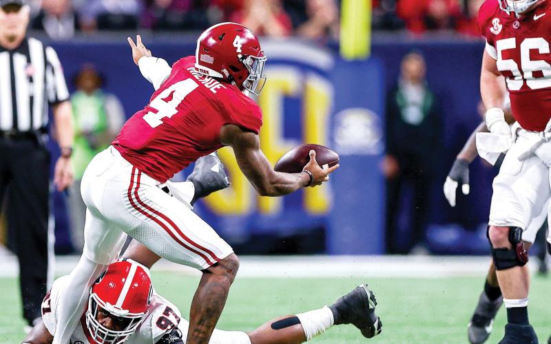 Georgia defensive lineman Warren Brinson (97) recorded a sack on Alabama quarterback Jalen Milroe (4), a tackle for loss and three tackles in the 2023 SEC Championship game in Atlanta. TONY WALSH/UGAAA