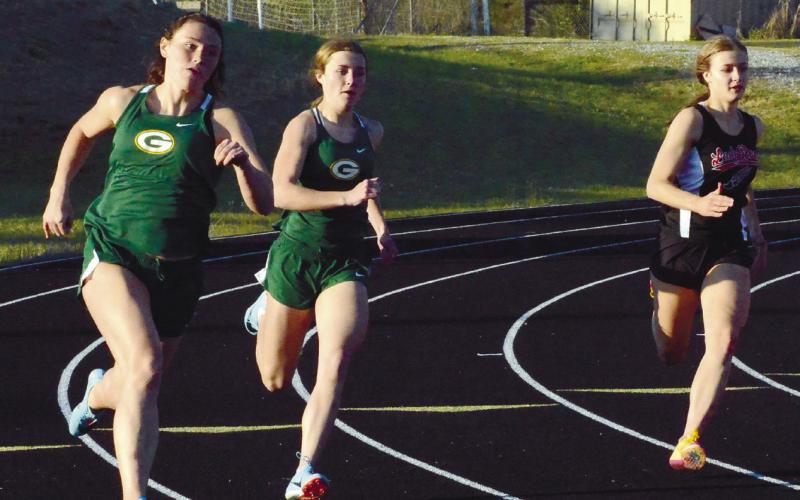 Madison Hevesy (left) and Natalie Sills (center) both had good results, with Hevesy second in the 200-meter dash, while both placed third on the Gators’ 4X400 relay team. IAN TOCHER/Staff