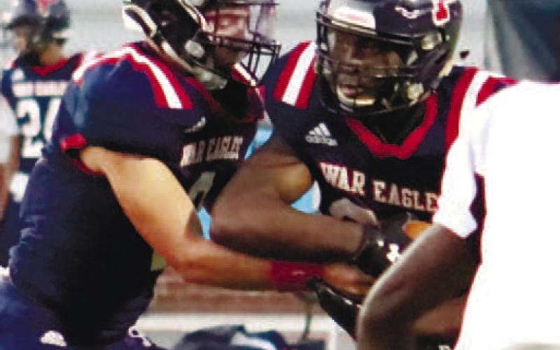 Quarterback Branan Griffin hands the ball off to Tamarion Peters in a game earlier this season. ARELLA CASH/Staff