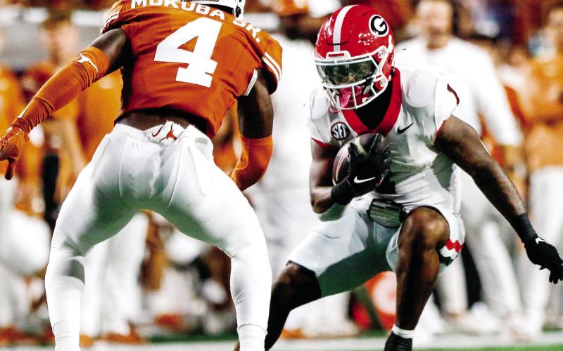 Georgia running back Trevor Etienne (1) accounted for all three Bulldog touchdowns in Austin. LANCE McCURLEY/Staff
