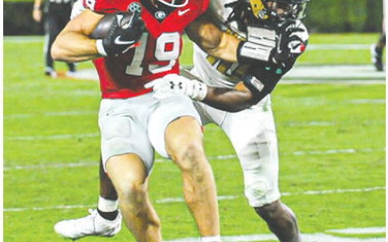 Brock Bowers sheds a defender as he makes his way to the end zone Saturday against UAB, a game in which the tight end scored three touchdowns. CHARLES JORDAN/Contributed