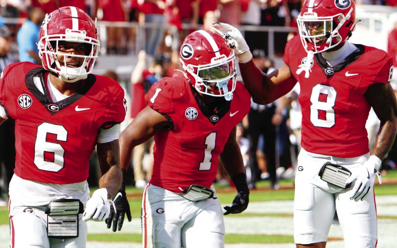 Georgia wide receiver Dominic Lovett (6), running back Trevor Etiennte (1) and wide receiver Colbie Young during Saturday’s win. LANCE McCURLEY/Staff