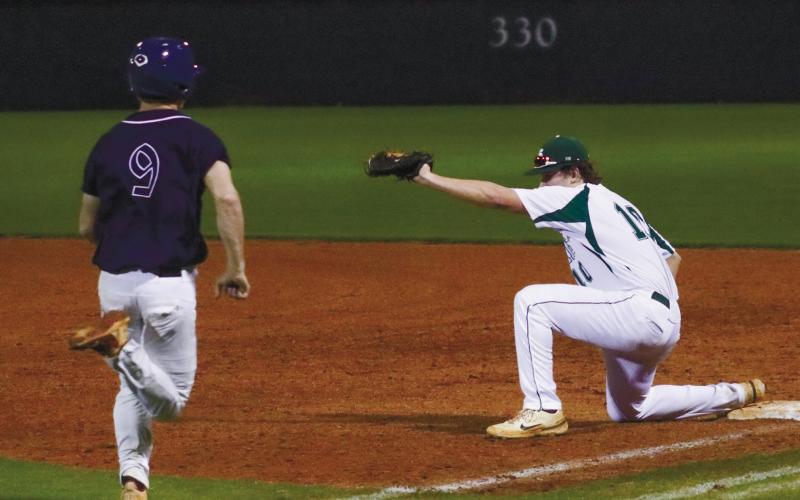 War Eagles’ freshman Wyatt Sims (9) tries to beat out a throw at the bag. LANCE McCURLEY/Staff