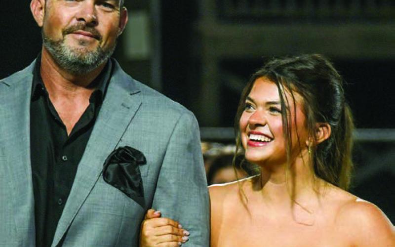 Miley Grace Sills escorted by her father Miles Sills. IAN TOCHER/Staff