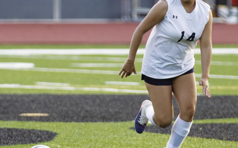 Senior striker Brenda Escutia (14) chases down a ball during a recent match for the Lady War Eagles. SKYLA MORRIS/Staff