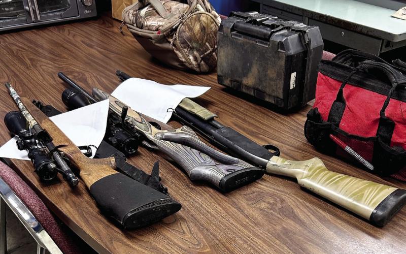 Eatonton police officers found these stolen rifles and a shotgun that two teens hid in the woods along with stolen bags of tools, trail cameras, and other hunting gear. The guns were loaded at the time. CONTRIBUTED/ EPD