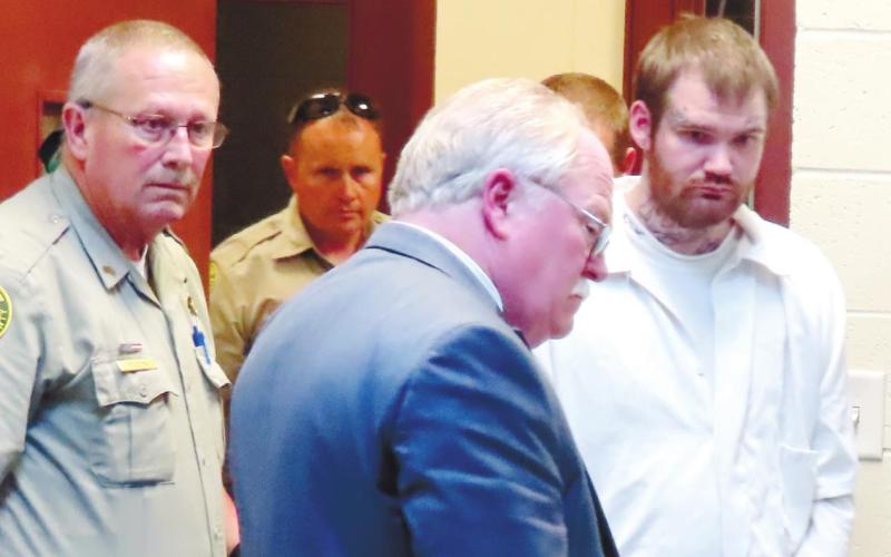No longer wearing a dress shirt and tie as he did throughout the trial, Ricky Dubose, far right, is shackled and in prison garb as he is escorted out of Putnam County Courthouse to be taken to the Georgia Department of Corrections’ Special Management Unit in Jackson. He is led by Putnam County Sheriff Howard R. Sills as well as Sgt. Bob Rogers and Deputy Chris Donovan. COURT POOL COVERAGE