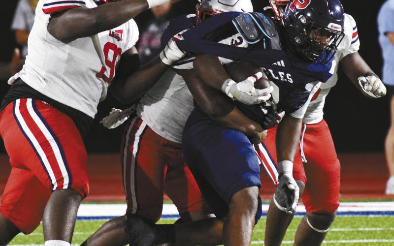 War Eagle running back Elijah Dunn carries three Laney Wildcats for extra yards during last Friday nights’ region contest. BRANDON PARK/Staff