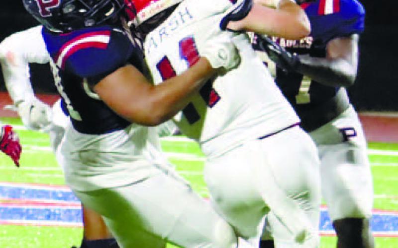 A couple of Putnam County defenders swallow up Toombs County running back Caden Marsh (24). ARELLA CASH/Staff