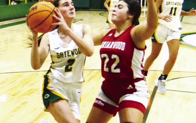 Junior Sarah Mansfield (2) goes up for a layup over Briarwood’s Aubrey Branan (22) in a 57-49 loss to the Lady Bucs on Dec. 20, 2023. KIM CASH/Staff
