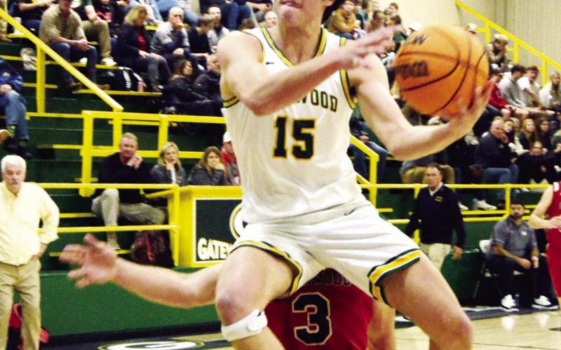 Gatewood’s Walker Roberts (15) drives hard to the net over Briarwood defender Mason Thigpen (3). KIM CASH/Staff