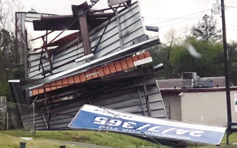 Twisted billboards were among signs of apparent tornado activity in Milledgeville. CONTRIBUTED