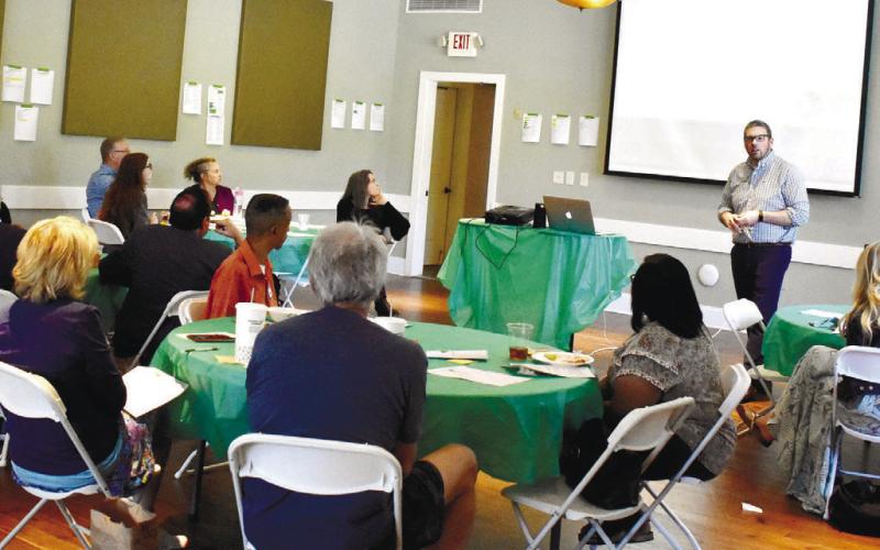 GaFCP Regional Manager Adam Swymer tells the Putnam County audience about summer plans. LENA HENSLEY/Staff
