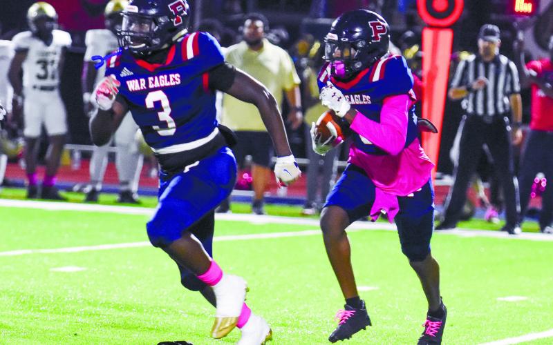 Putnam County running back Rashod Daniel (3) blocks for teammate Kaleb Crawford (9) as he runs in open field. LANCE McCURLEY/Staff