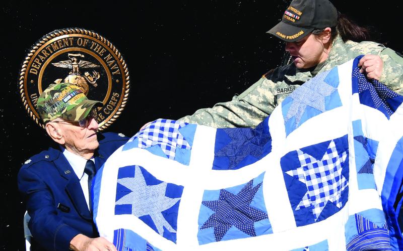 After addressing the crowd with a humorous but heartfelt speech, centenarian and retired U.S. Air Force Lt. Col. Billy Hargrove received a handmade quilt from event organizer Nikki Barker. IAN TOCHER/Staff