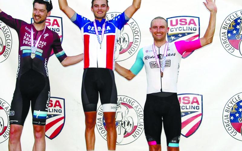 Senoia’s Caleb Landgrebe, winner of the criterium race in the Georgia State Championships last Saturday in Eatonton, stands between second-place finisher Jos Chalmers (left) and third-place Forrest Howard. CALEB LANDGREBE/Photo courtesy Facebook